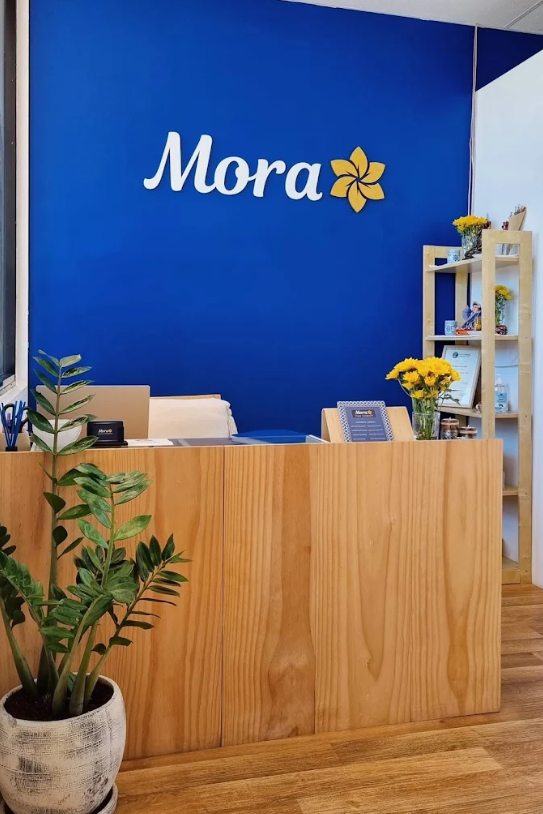 Mora Thai Therapy reception with blue wall and logo